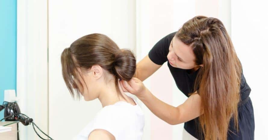 Hairdresser making hair bun