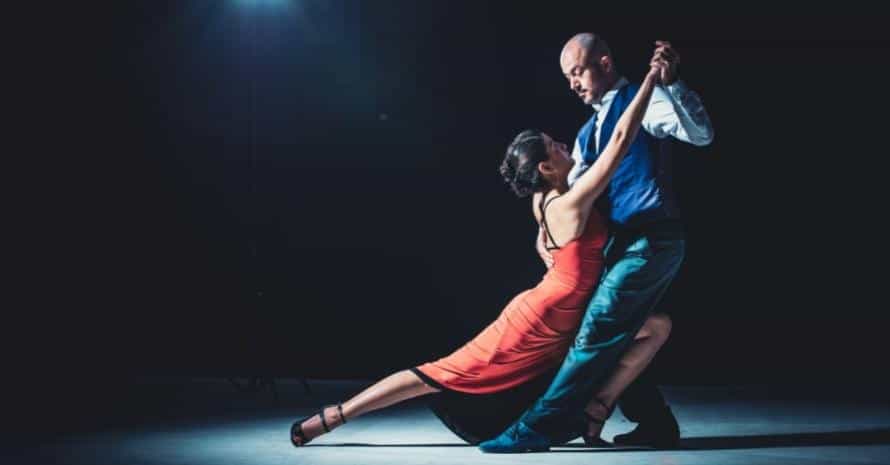 Woman and man dancing under the lights